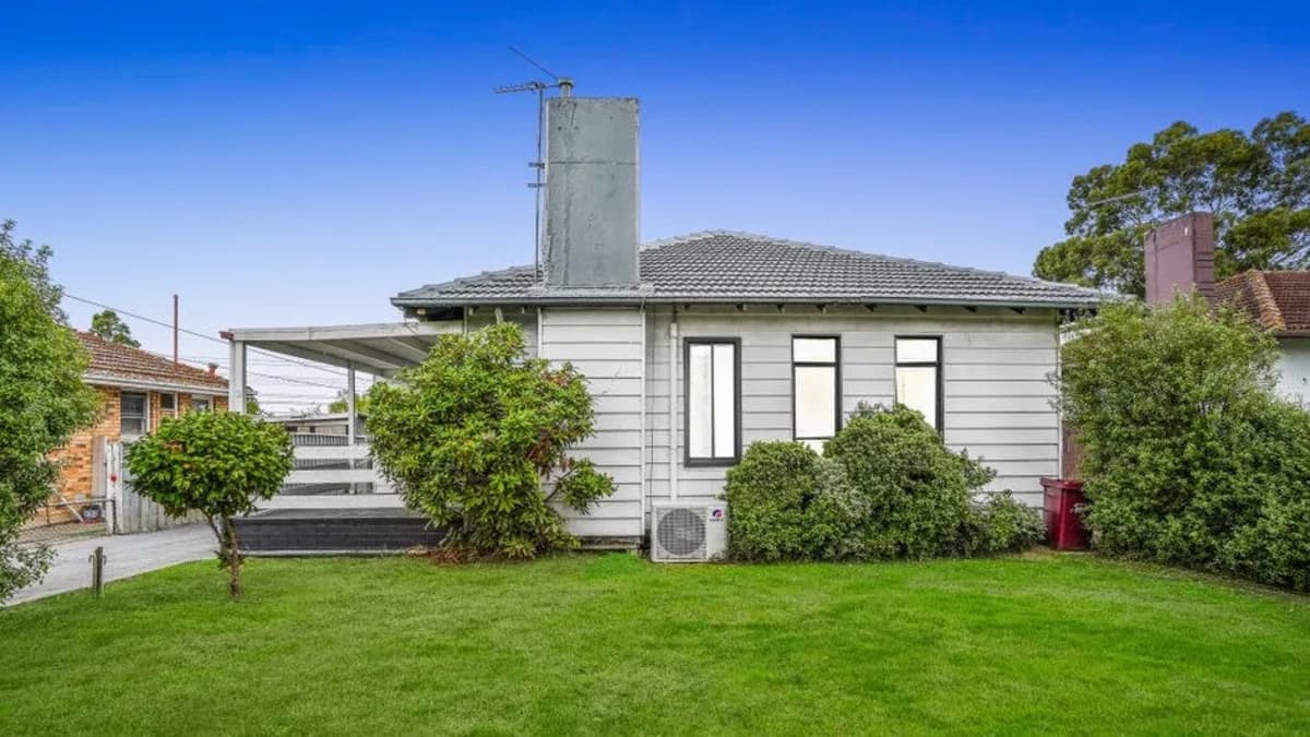 Classic Australian weatherboard home with green lawn
